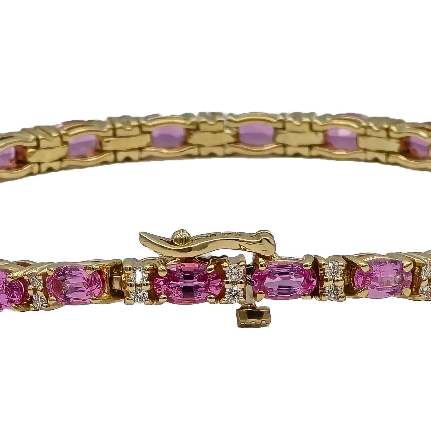 closeup of oval pink sapphire and diamond bracelet in 14K yellow gold