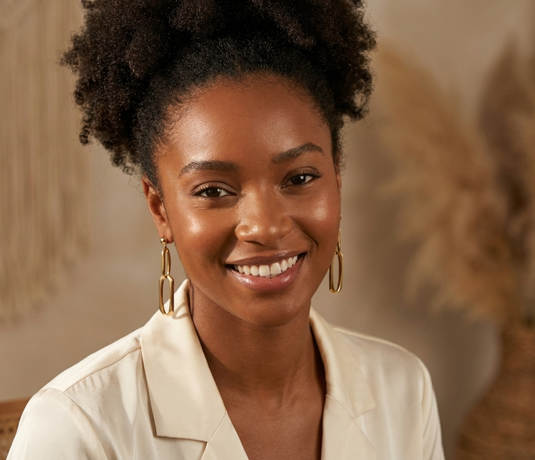 A photo of a woman wearing gold earrings.  This link will take you to Heileman & Company Jewelers selection of gold fashion jewelry.