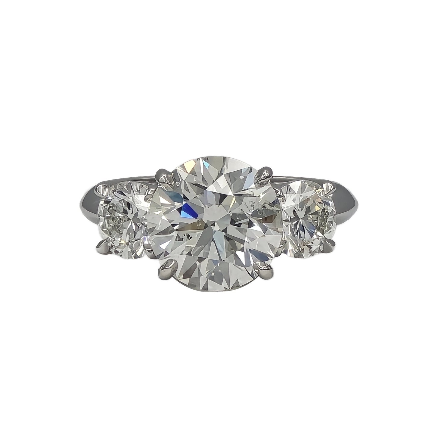 3.47ct and 2=1.40ctw round brilliant cut 3 stone ring in platinum