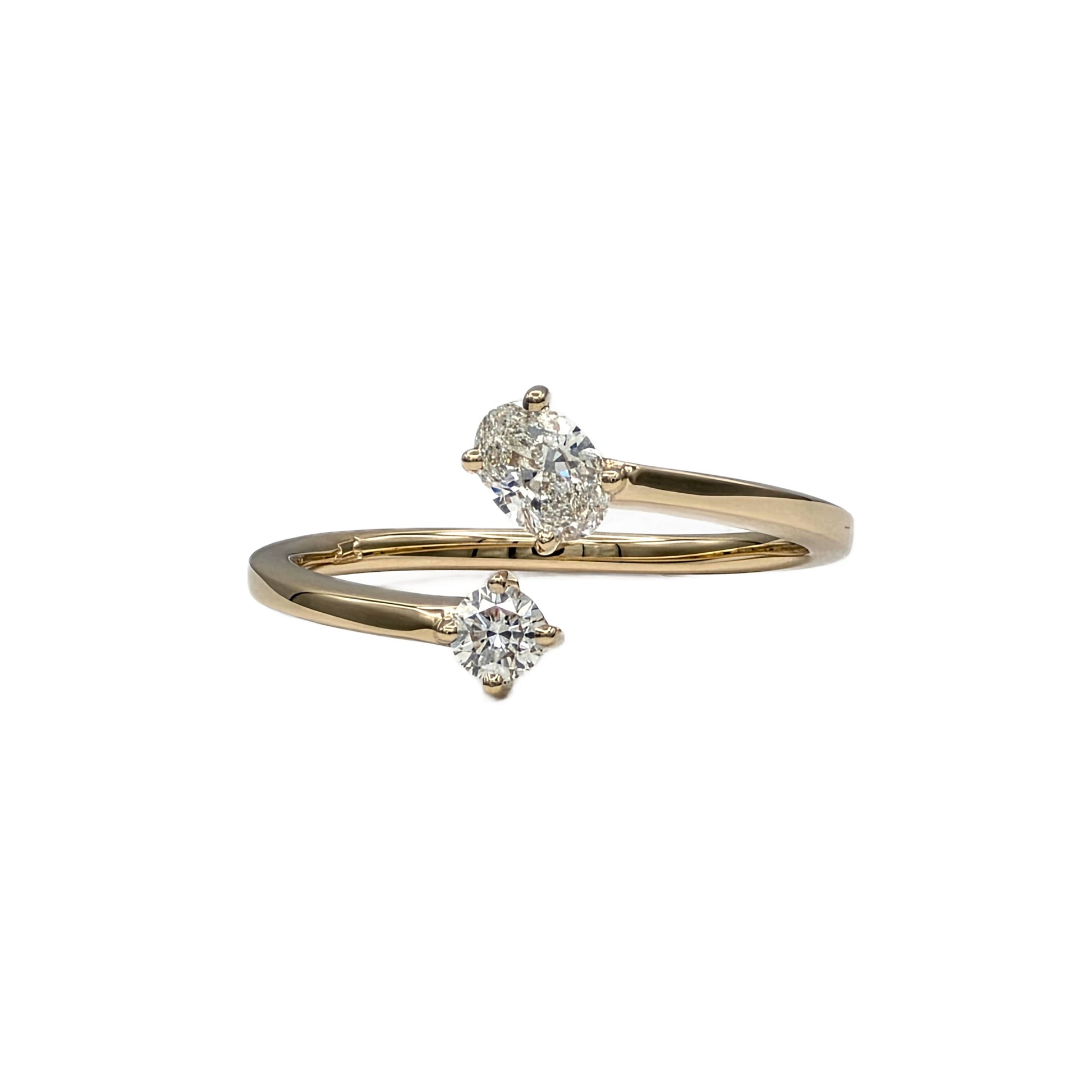Oval and round diamond bypass ring in 14K yellow gold